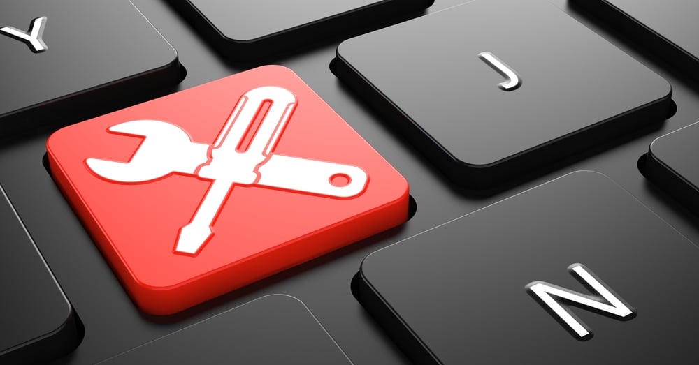 Crossed Screwdriver and Wrench on Red Button on Black Computer Keyboard | ESB Professional / Shutterstock