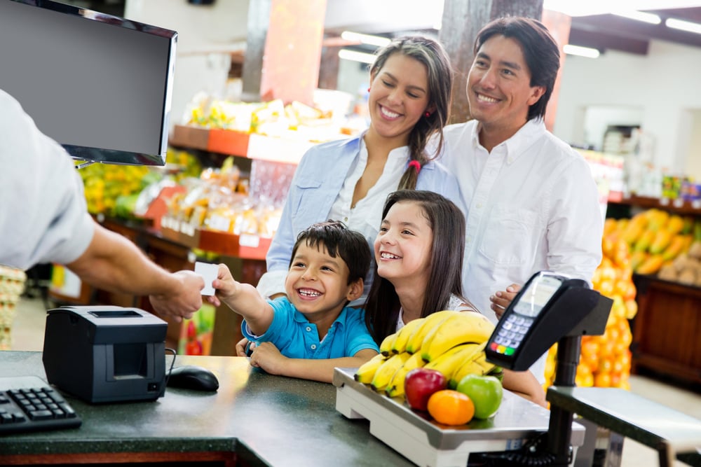 Family looking out for home finances at the supermarket | ESB Professional / Shutterstock