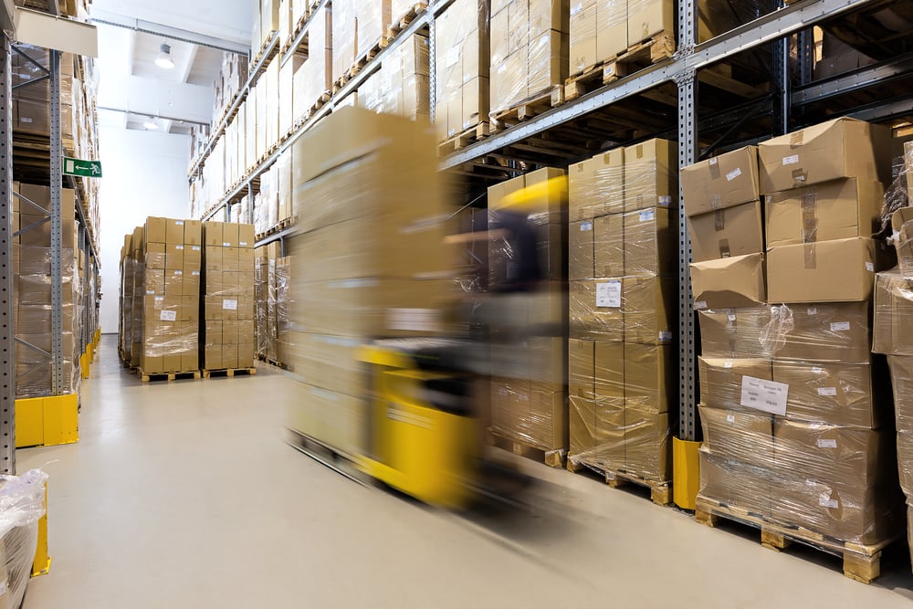 Fork lift operator preparing products for shipment | ESB Professional / Shutterstock