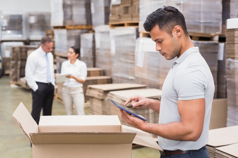 Portrait of male manager using digital tablet in warehouse | ESB Professional / Shutterstock