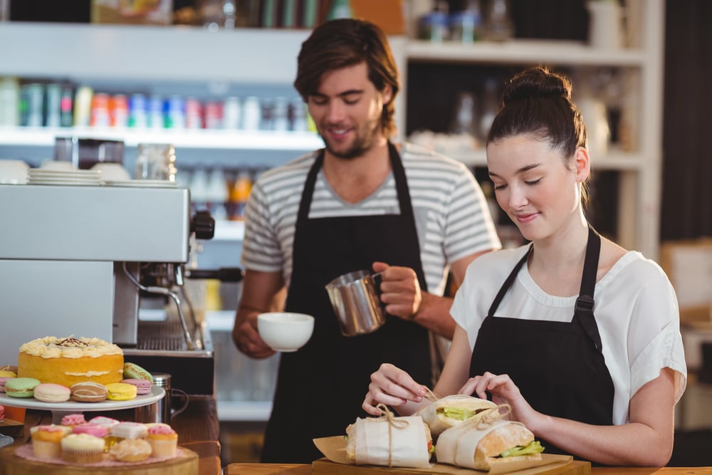 Waiter and waitress working behind the counter in caf? | ESB Professional / Shutterstock
