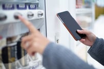 Woman use of soft drink vending system paying by cellphone | Source: ESB Professional / Shutterstock 